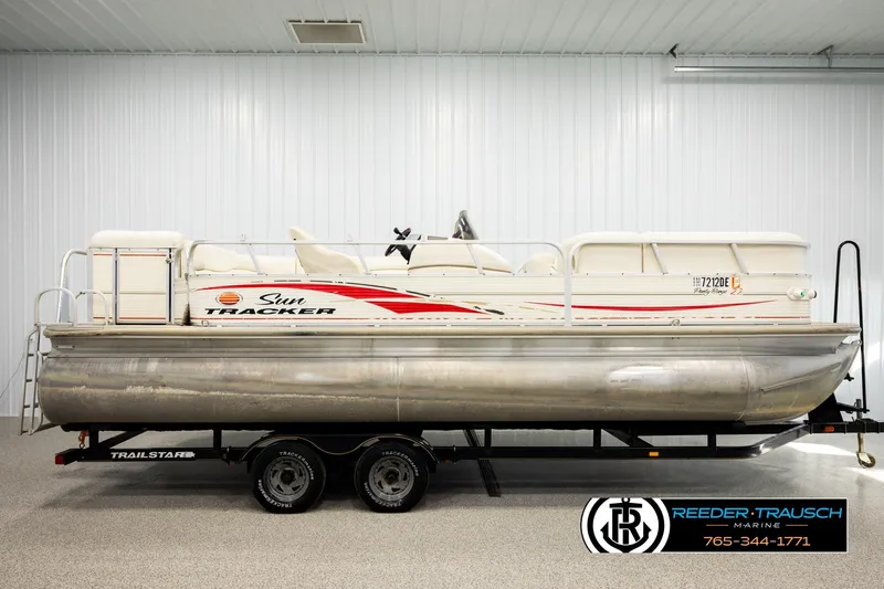 Slide: The Image of 2006 Sun Tracker Party Barge 22 Regency Edition pontoon boat on a trailer indoors. - 4