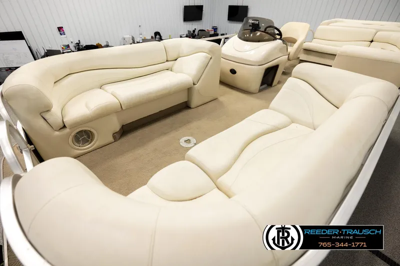 Slide: The Image of 2006 Sun Tracker Party Barge 22 Regency Edition with luxurious beige seating and helm. - 9