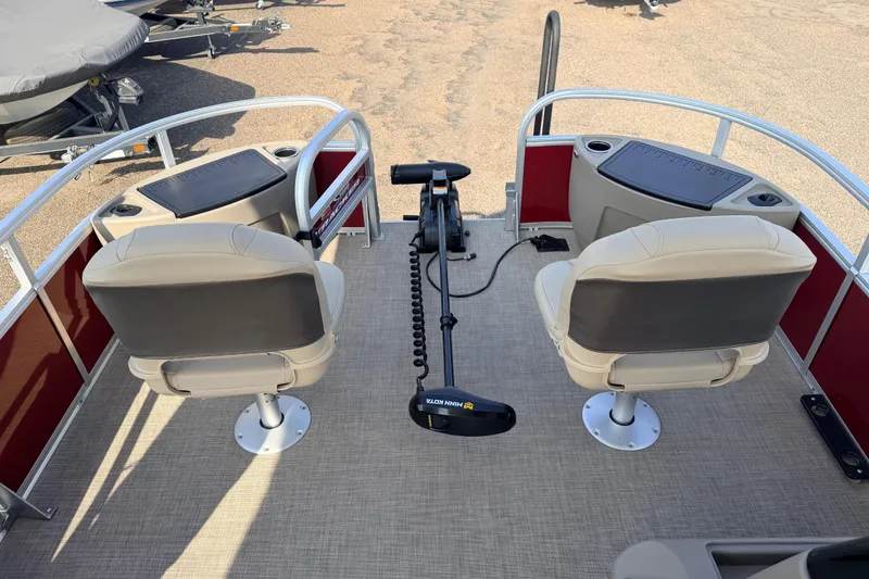 Slide: The Image of 2025 Sun Tracker Bass Buggy 18 DLX pontoon boat interior with two seats and control panel. - 92