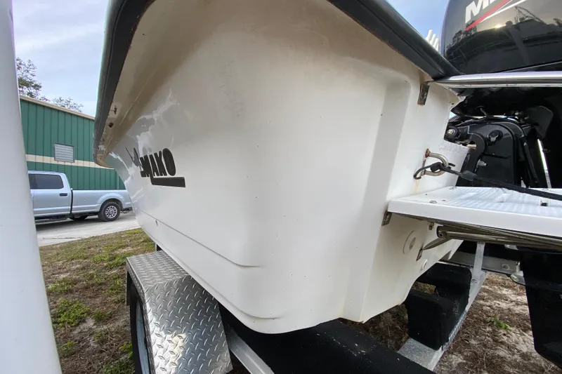 Slide: The Image of 2006 Mako 191 Inshore boat on trailer, side view near green building. - 10