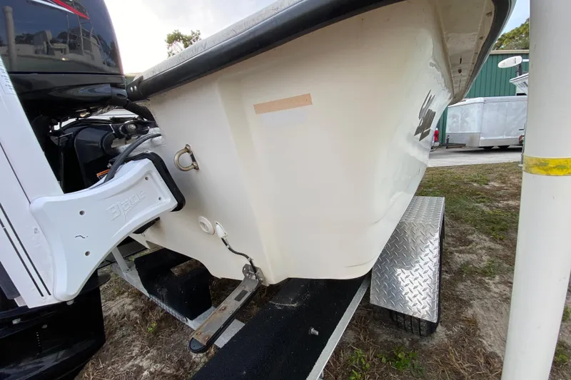 Slide: The Image of 2006 Mako 191 Inshore boat on trailer, showing rear and side view. - 16