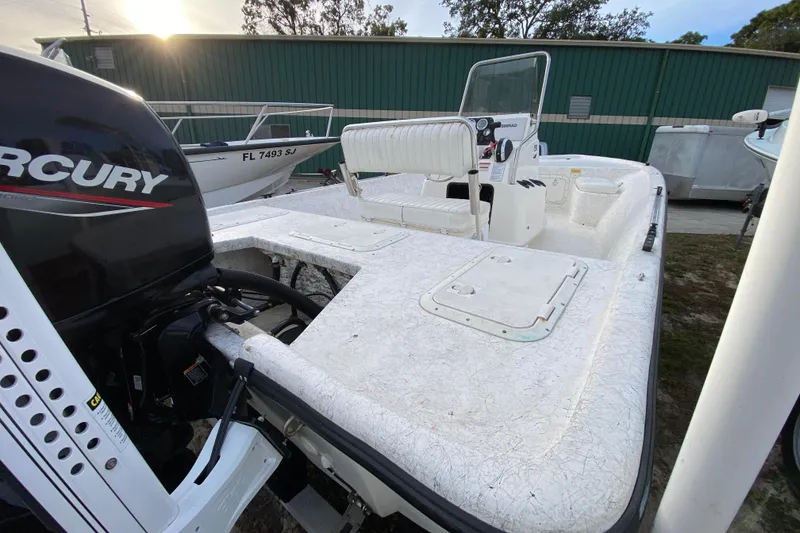 Slide: The Image of 2006 Mako 191 Inshore boat with Mercury engine, parked outdoors. - 21