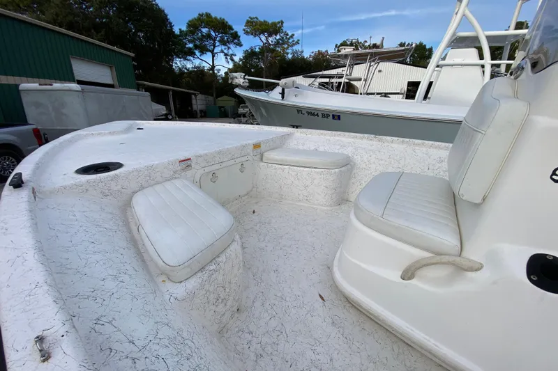 Slide: The Image of 2006 Mako 191 Inshore boat interior with white seating and storage compartments. - 25