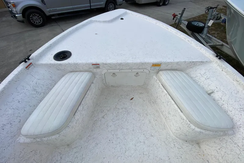 Slide: The Image of 2006 Mako 191 Inshore boat interior with white seating and storage compartment. - 27