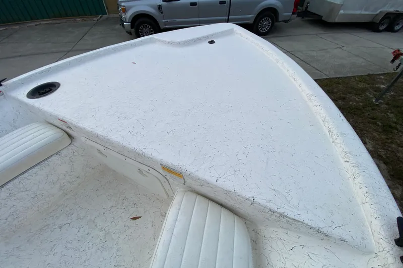 Slide: The Image of 2006 Mako 191 Inshore boat deck with textured white surface and seating. - 28