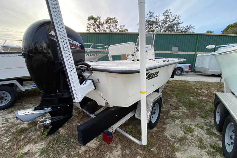 Slide: The Image of 2006 Mako 191 Inshore boat with Mercury engine on trailer, parked outdoors. - 3