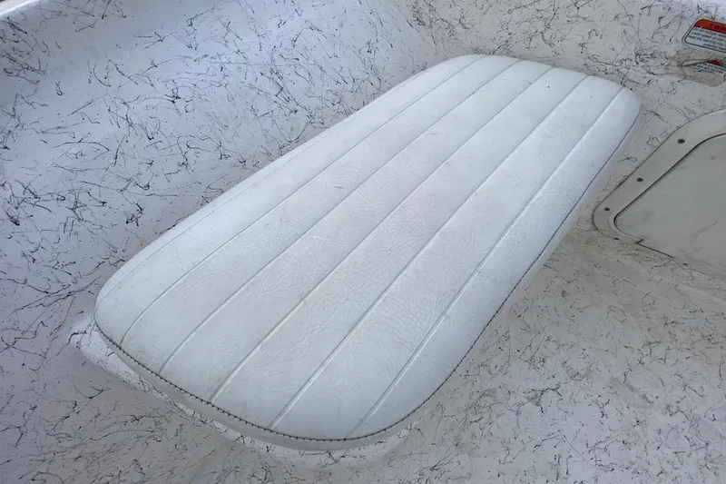 Slide: The Image of White cushioned seat on 2006 Mako 191 Inshore boat with textured surface. - 30