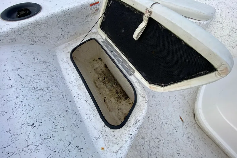 Slide: The Image of Open storage compartment on a 2006 Mako 191 Inshore boat, showing interior details. - 31