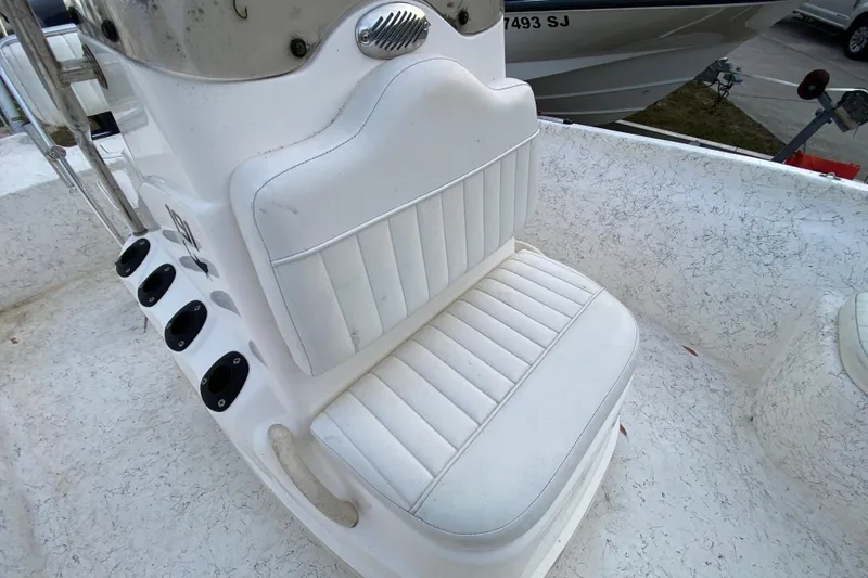 Slide: The Image of White seating on a 2006 Mako 191 Inshore boat, featuring rod holders. - 37