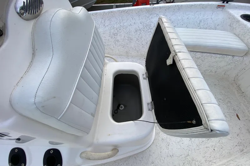 Slide: The Image of 2006 Mako 191 Inshore boat with open storage compartment and white seating. - 38