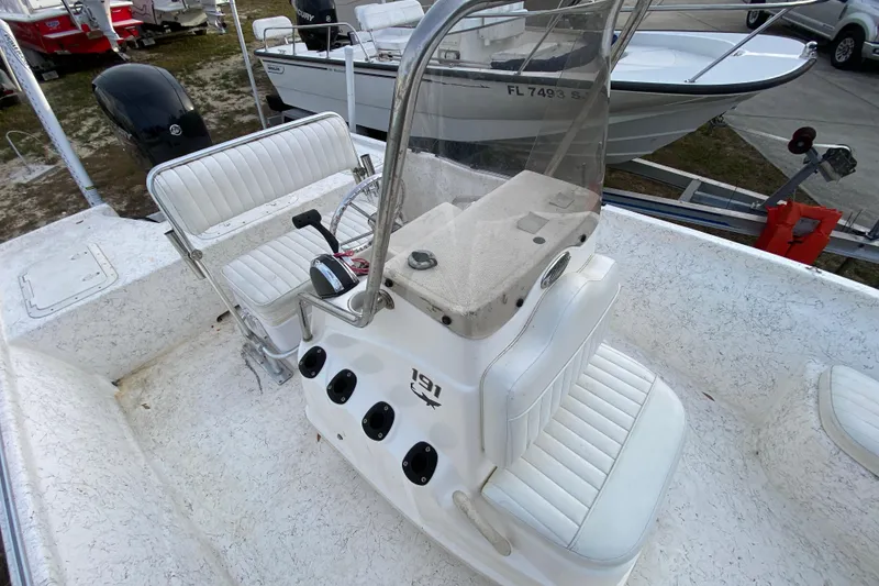 Slide: The Image of 2006 Mako 191 Inshore boat interior with white seating and control console. - 40