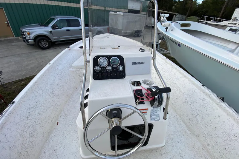 Slide: The Image of 2006 Mako 191 Inshore boat console with steering wheel and Simrad navigation system. - 42