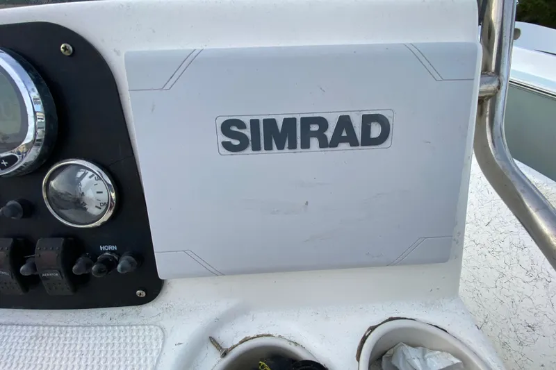 Slide: The Image of Console of a 2006 Mako 191 Inshore boat featuring Simrad electronics. - 44