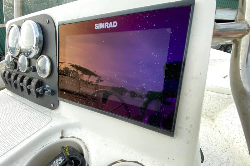 Slide: The Image of Dashboard of a 2006 Mako 191 Inshore boat with Simrad display and gauges. - 45