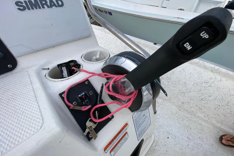 Slide: The Image of Control panel of a 2006 Mako 191 Inshore boat with throttle and ignition keys. - 46