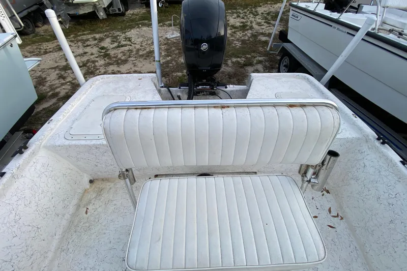 Slide: The Image of 2006 Mako 191 Inshore boat interior with white seating and outboard motor. - 50