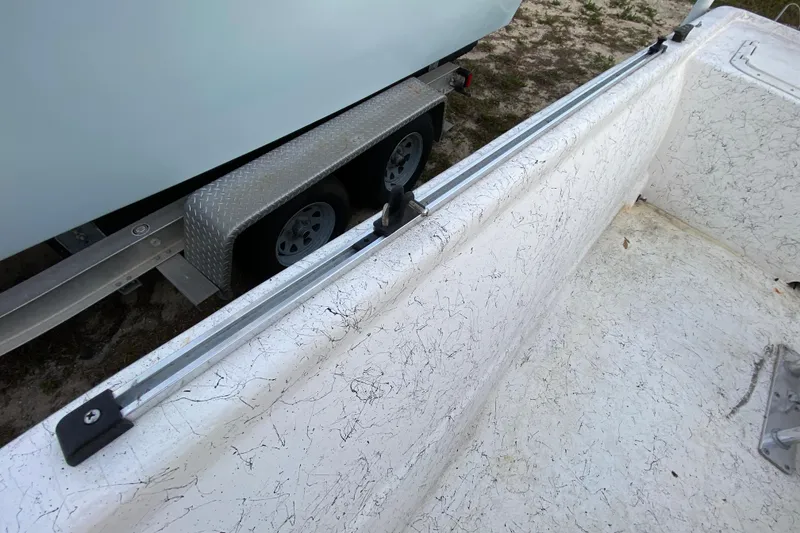 Slide: The Image of 2006 Mako 191 Inshore boat interior with trailer in background. - 53