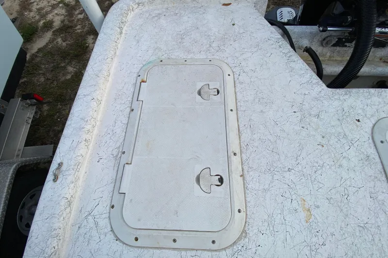 Slide: The Image of 2006 Mako 191 Inshore boat deck with hatch cover, showing wear and texture. - 55