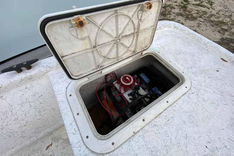 Slide: The Image of Open hatch on 2006 Mako 191 Inshore boat showing battery compartment and wiring. - 56