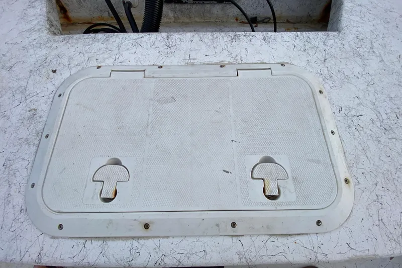 Slide: The Image of Hatch cover on a 2006 Mako 191 Inshore boat deck. - 58