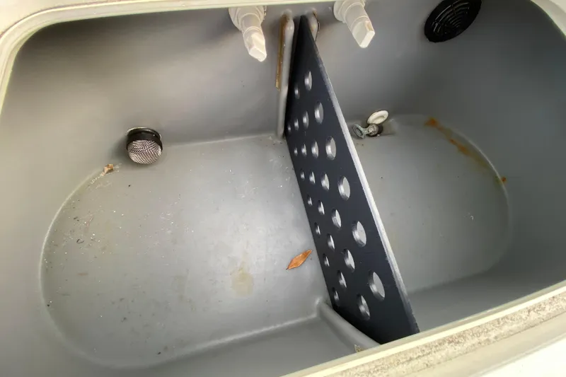 Slide: The Image of Livewell interior of a 2006 Mako 191 Inshore boat, featuring drainage and aeration systems. - 60