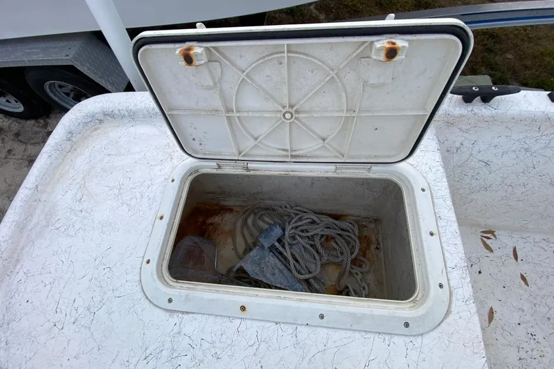 Slide: The Image of Open storage compartment on 2006 Mako 191 Inshore boat with rope and anchor. - 62