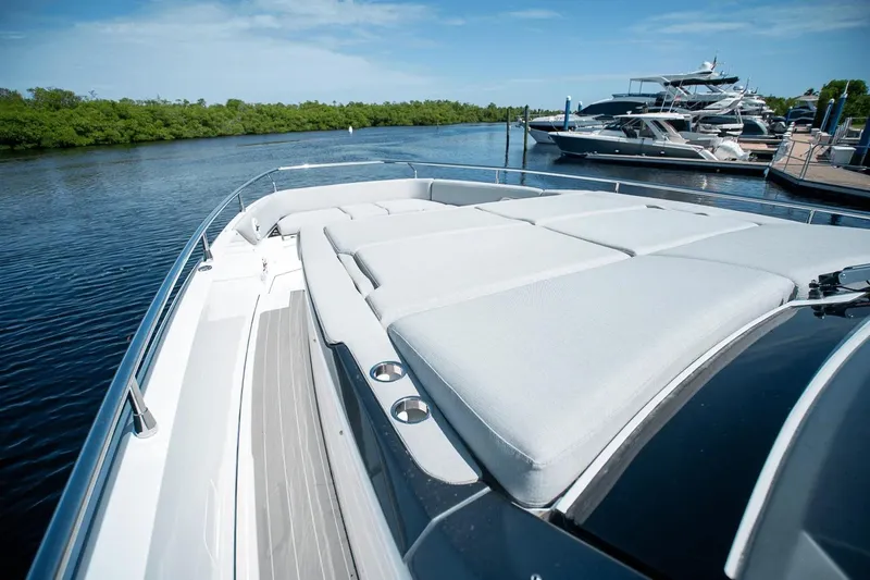 Slide: The Image of 2026 Azimut Verve 42 yacht with spacious sunbathing area, docked by serene waters. - 33