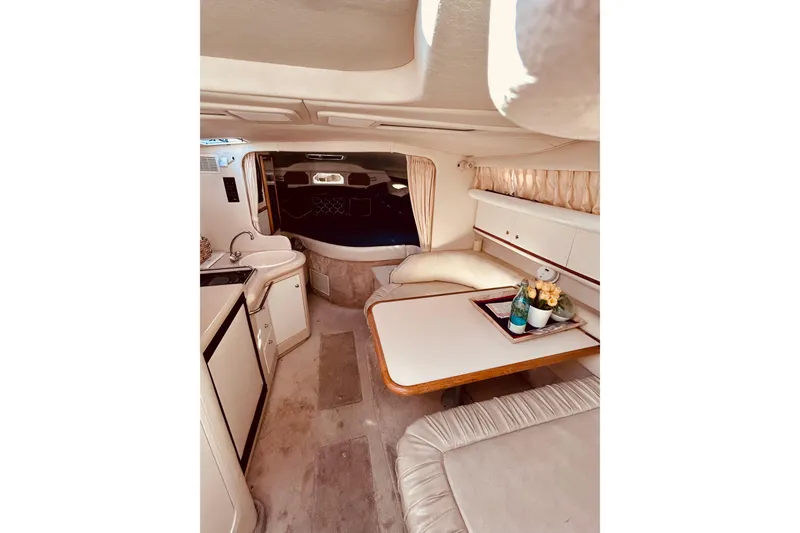 Slide: The Image of Interior of 1999 Sea Ray Sundancer 330, featuring cozy seating and elegant decor. - 17