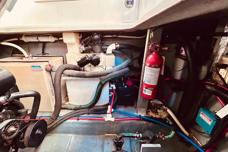Slide: The Image of Engine compartment of a 1999 Sea Ray Sundancer 330 with fire extinguisher and mechanical components. - 22