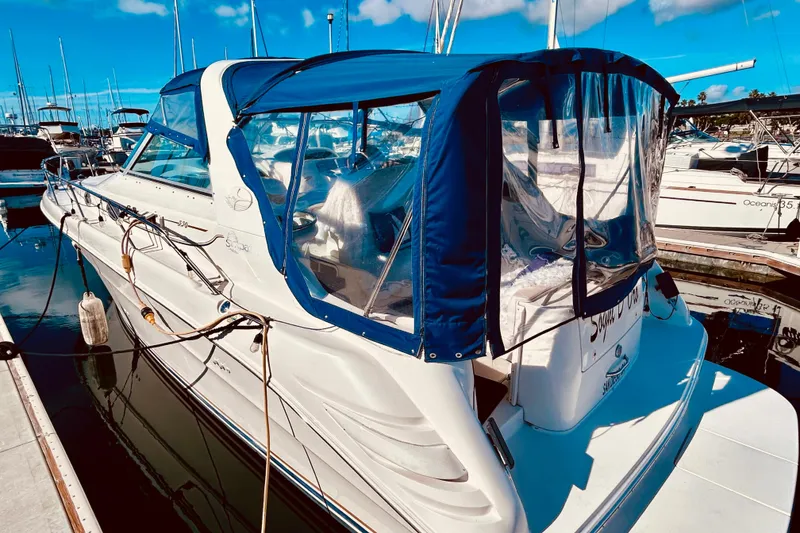 Slide: The Image of 1999 Sea Ray Sundancer 330 docked at marina under clear blue sky. - 5