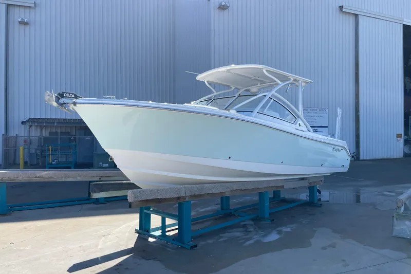 The Image of 2017 Edgewater 248CX Crossover boat on display in a marina setting. - 0