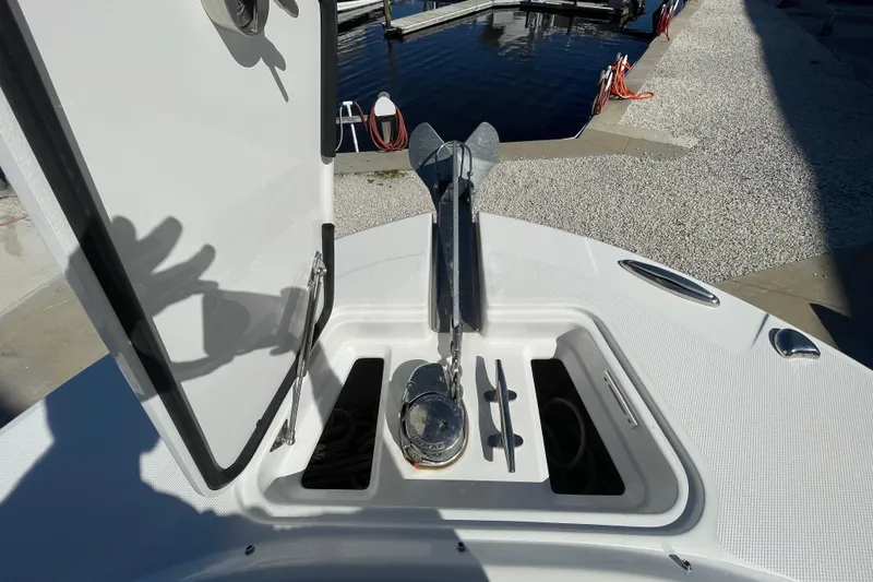 Slide: The Image of Open anchor compartment on 2017 Edgewater 248CX Crossover boat at dockside. - 10
