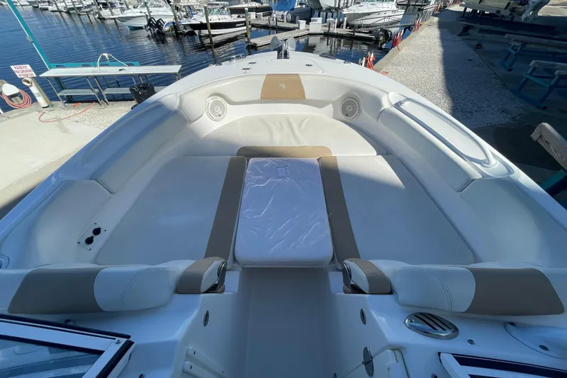 Slide: The Image of 2017 Edgewater 248CX Crossover boat interior with spacious seating at marina. - 13