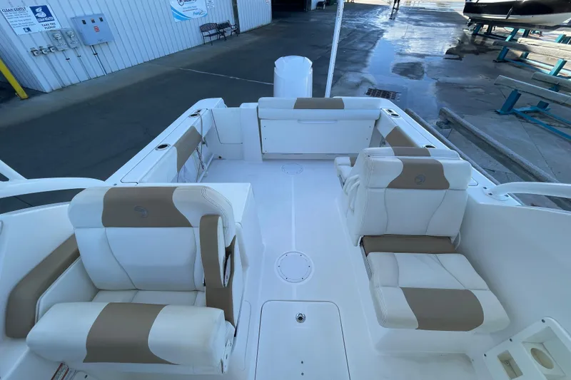 Slide: The Image of 2017 Edgewater 248CX Crossover boat interior with white and tan seating. - 15