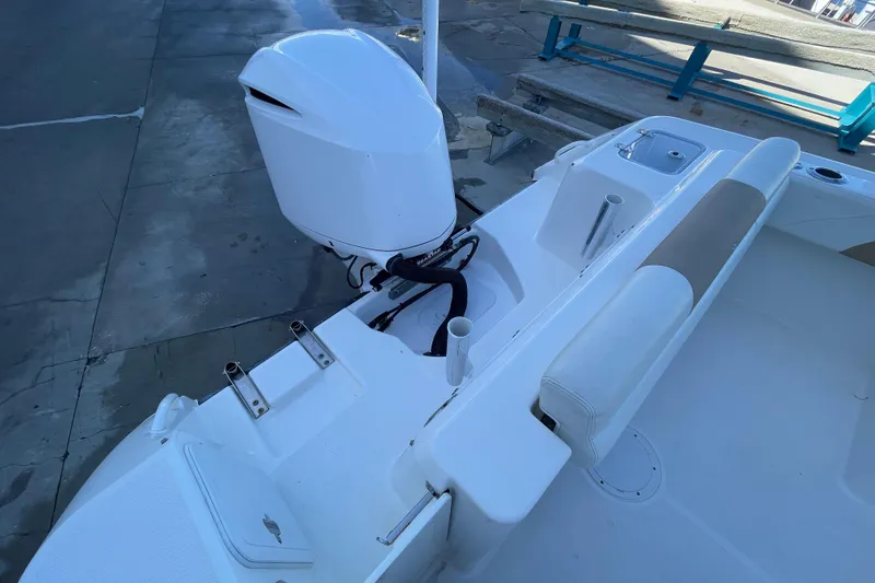 Slide: The Image of 2017 Edgewater 248CX Crossover boat with outboard motor and seating area. - 19