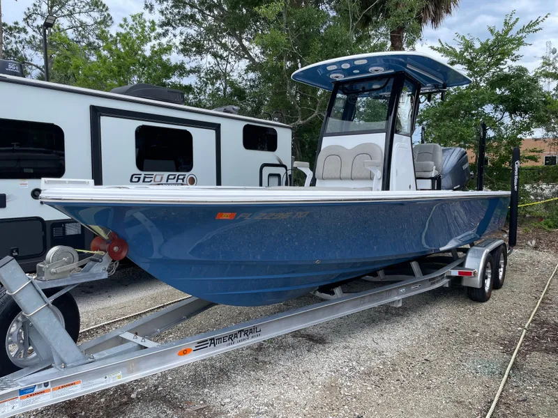 The Image of 2022 Sportsman Masters 247OE Bay Boat on trailer, parked near RV. - 0
