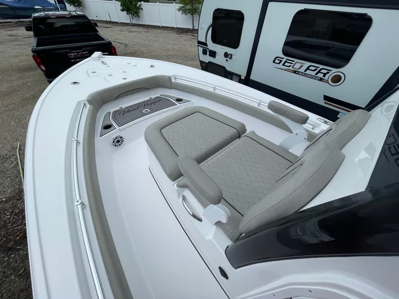 Slide: The Image of 2022 Sportsman Masters 247OE Bay Boat with cushioned seating and sleek design. - 11