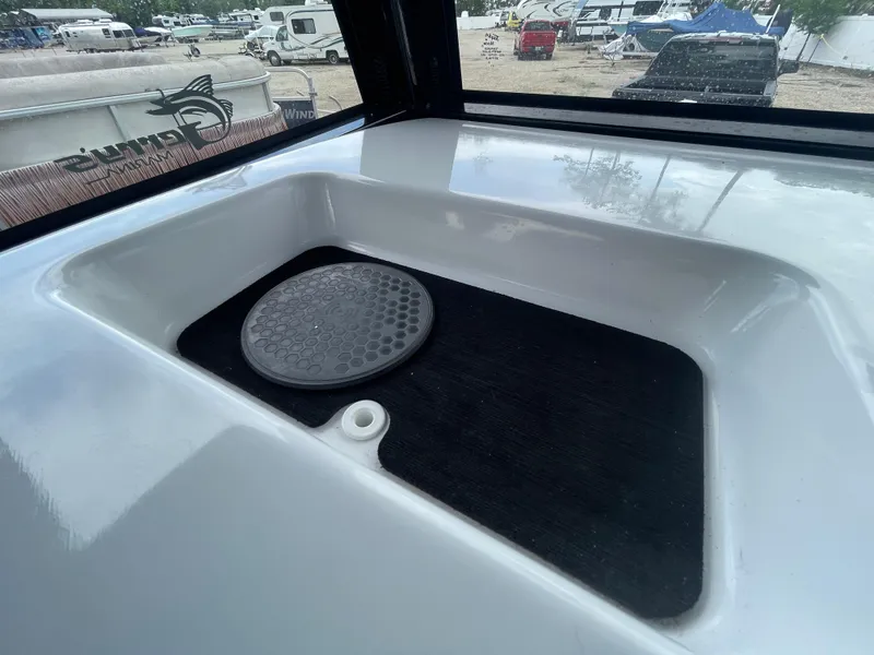 Slide: The Image of 2022 Sportsman Masters 247OE Bay Boat interior detail with storage compartment. - 15
