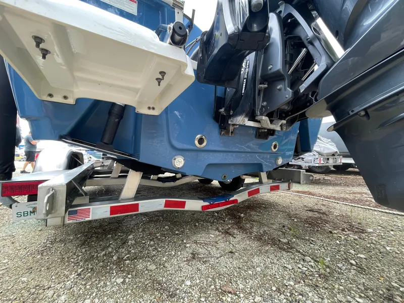 Slide: The Image of 2022 Sportsman Masters 247OE Bay Boat on trailer, rear view showing hull and outboard motor. - 25
