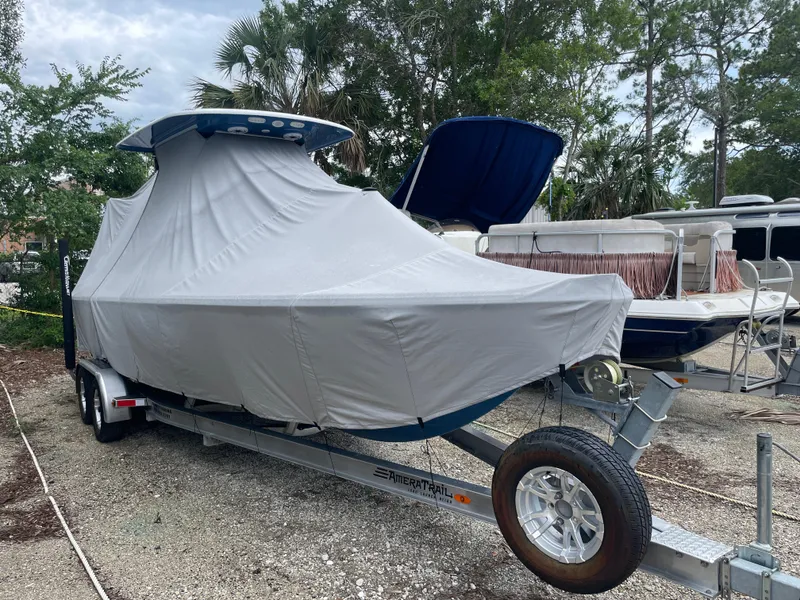 Slide: The Image of 2022 Sportsman Masters 247OE Bay Boat covered on trailer in outdoor storage. - 29