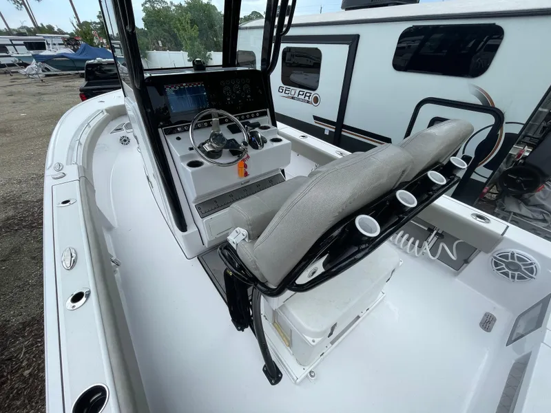 Slide: The Image of 2022 Sportsman Masters 247OE Bay Boat interior with console and seating. - 5