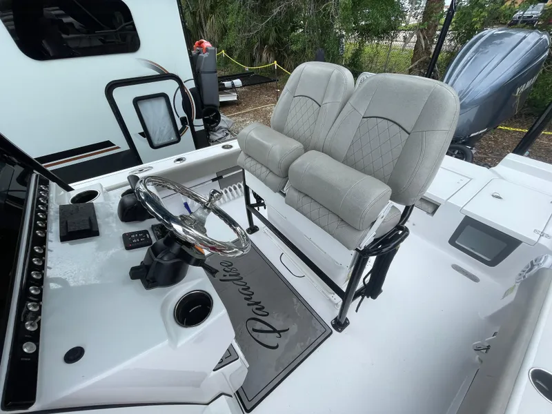 Slide: The Image of 2022 Sportsman Masters 247OE Bay Boat interior with dual seats and steering console. - 6