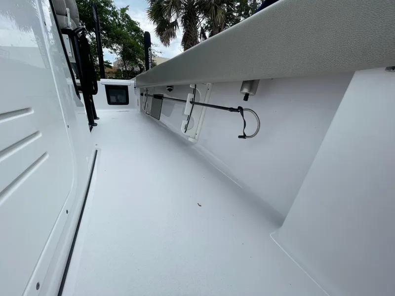 Slide: The Image of 2022 Sportsman Masters 247OE Bay Boat interior with rod holders and storage compartments. - 9