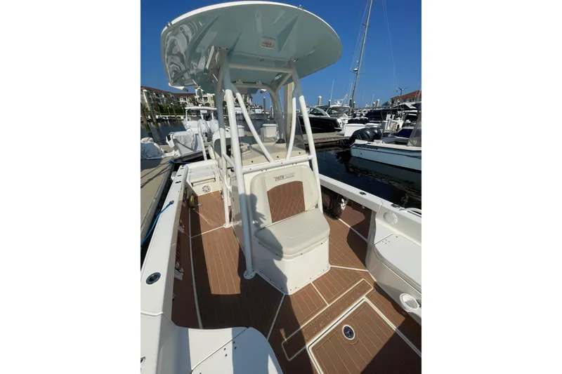 Slide: The Image of 2021 Pathfinder 2600 TRS boat docked, featuring a spacious deck and modern design. - 11