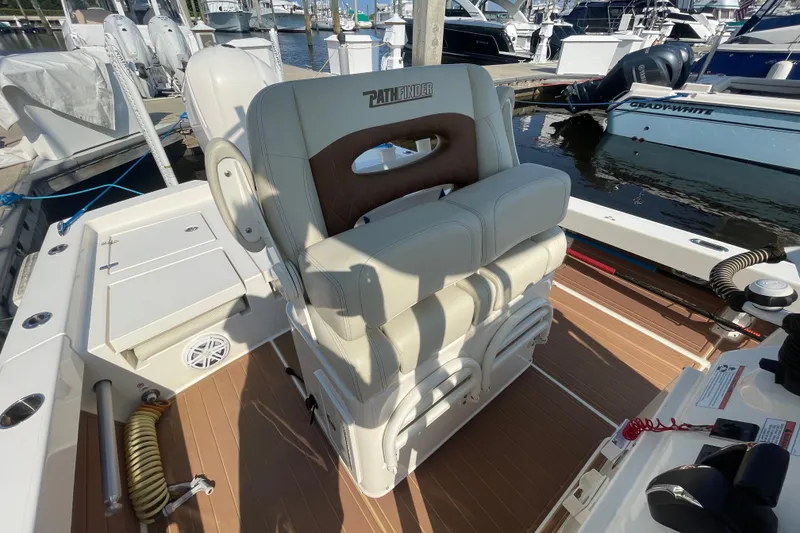 Slide: The Image of 2021 Pathfinder 2600 TRS boat interior with seating at marina dock. - 14