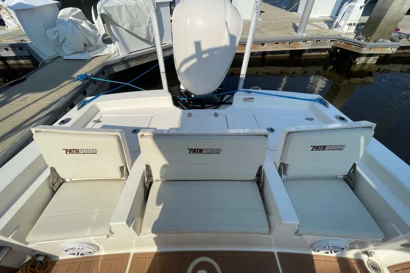 Slide: The Image of 2021 Pathfinder 2600 TRS boat with three cushioned seats at the dock. - 16