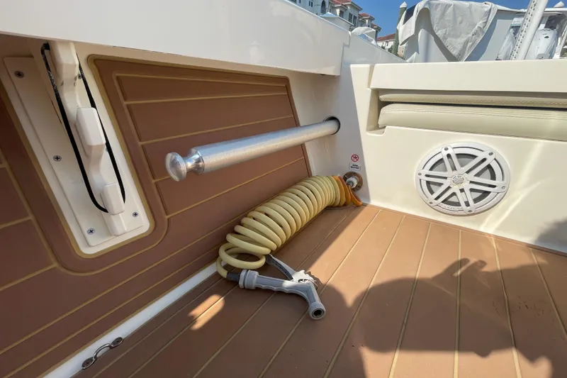 Slide: The Image of 2021 Pathfinder 2600 TRS boat deck with hose, speaker, and rod holder. - 17