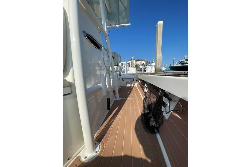 Slide: The Image of 2021 Pathfinder 2600 TRS boat deck with fishing net, docked at marina. - 18