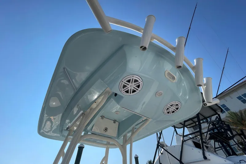 Slide: The Image of 2021 Pathfinder 2600 TRS boat underside with rod holders and speakers against clear sky. - 19