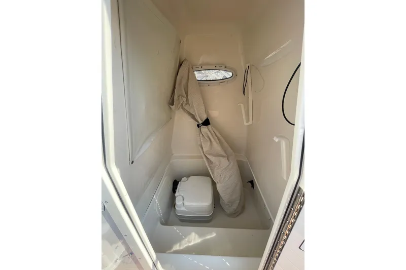 Slide: The Image of 2021 Pathfinder 2600 TRS boat interior with compact toilet and storage area. - 21